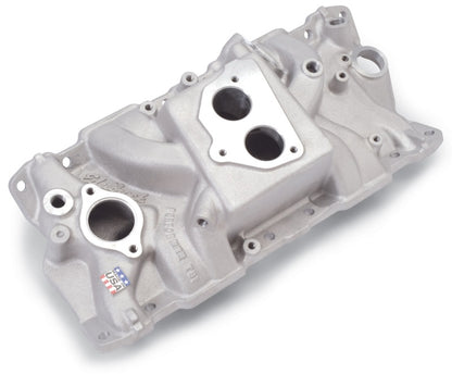 Edelbrock Perf T B I Manifold w/ Egr installed on a 1994 Chevy TBI engine bay showing aluminum finish and EGR passages.