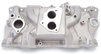 Edelbrock Perf T B I Manifold w/ Egr installed on a 1994 Chevy TBI engine bay showing aluminum finish and EGR passages.